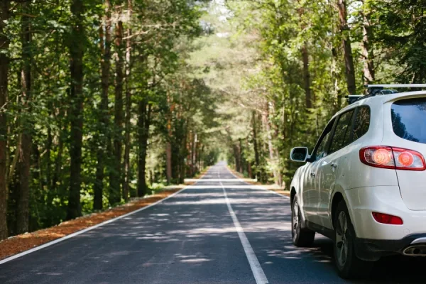 Car driving along a winding mountain road, representing taxi service